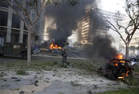 Fires burn and smoke rises from the site of an explosion in Beirut downtown area