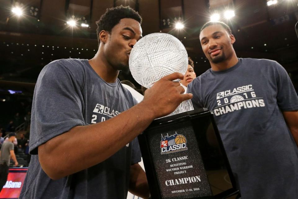 Michigan's Derrick Walton kisses the 2K Classic Trophy (Getty Images)