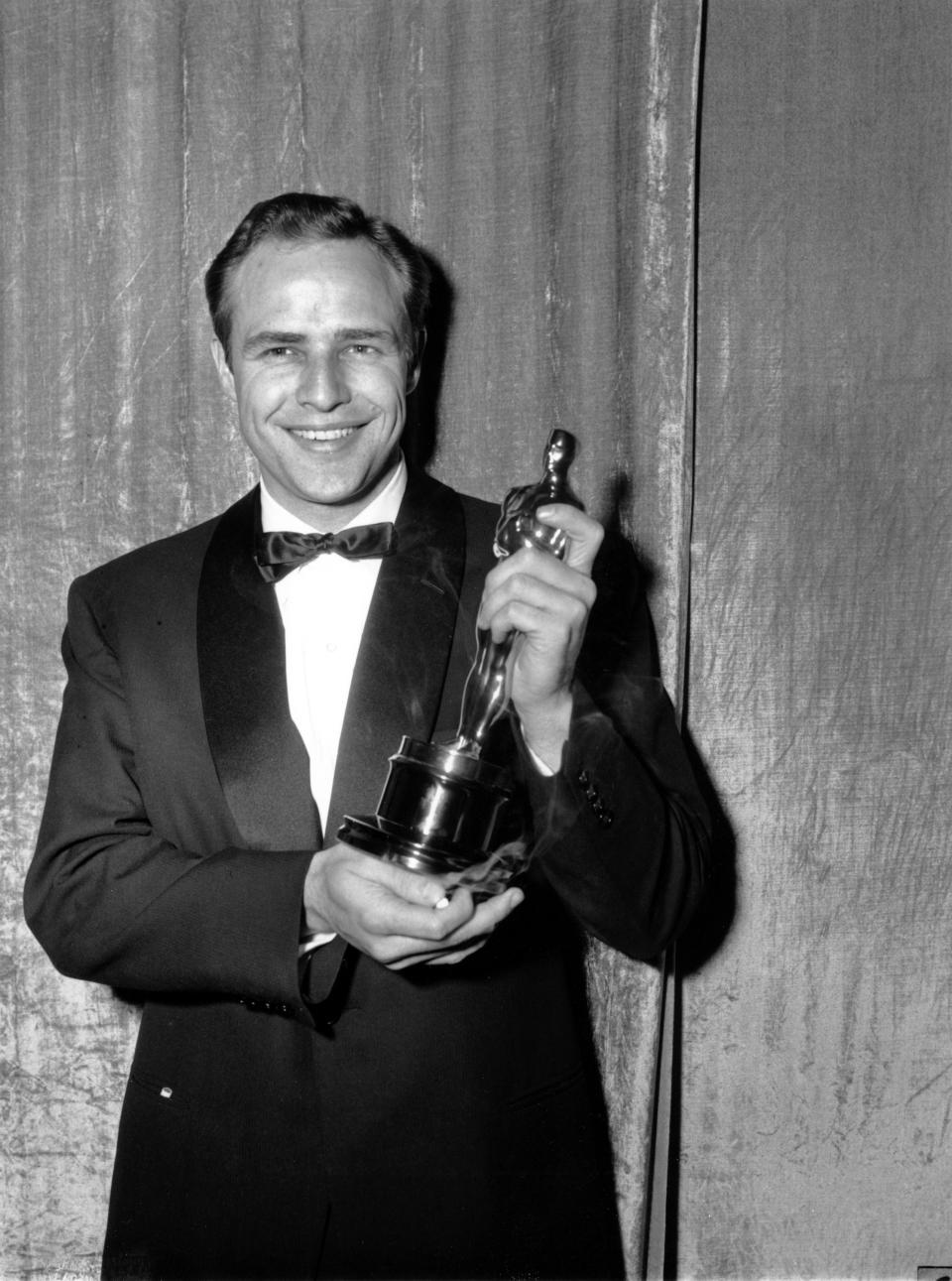 Oscar-winner Marlon Brando poses with his statuette at the 27th Annual Academy Awards at Pantages Theater in Hollywood, Ca. on March 30, 1955.  Brando won best actor of the year for his portrayal in 