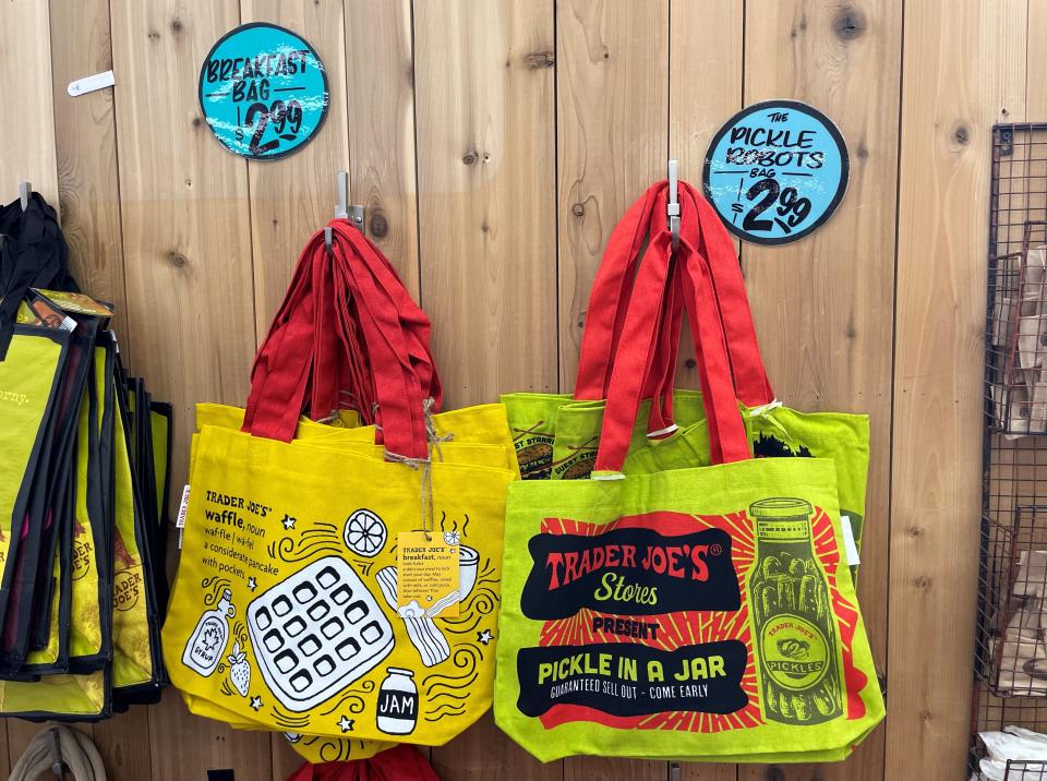 trader joe's reusable bags on hooks with a wood background