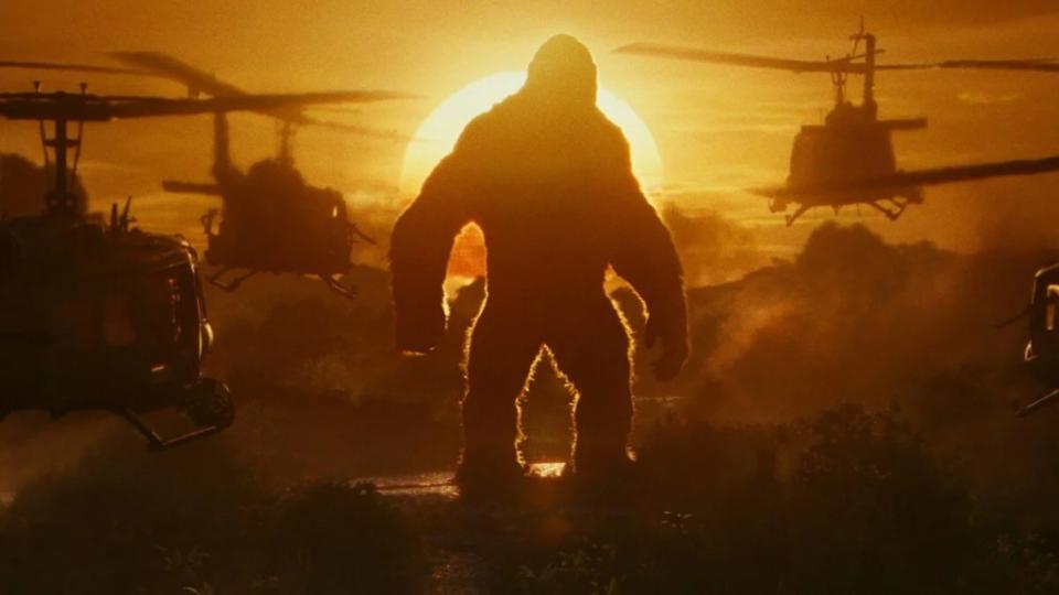 King Kong stands in the sunset as helicopters fly by