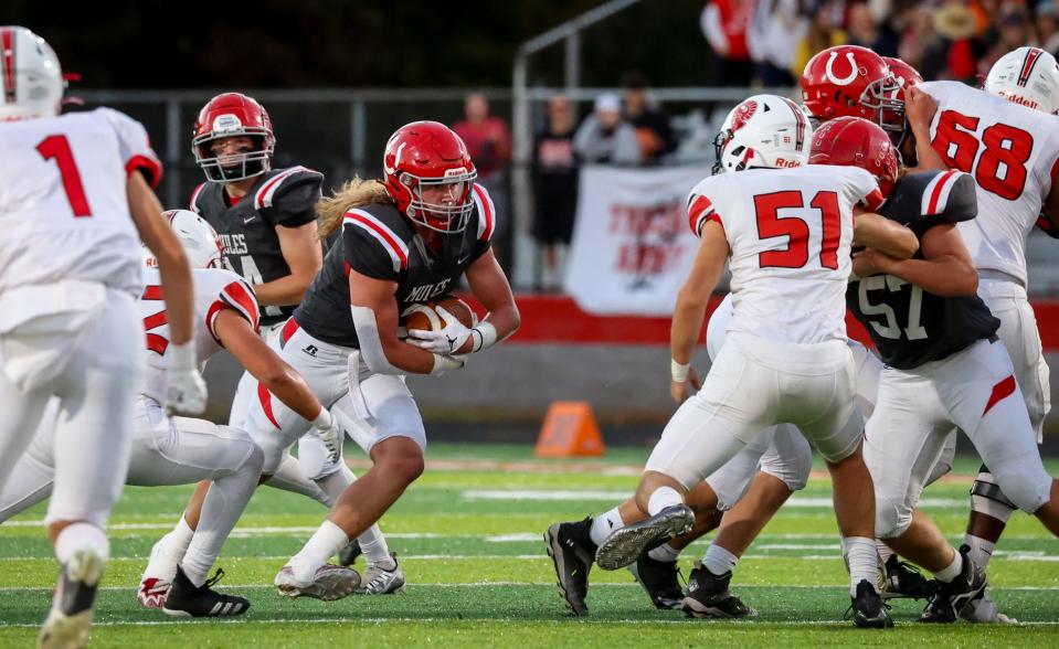 Trey Brueggemann carries the ball for Bedford during a 28-14 win over Monroe Friday night.