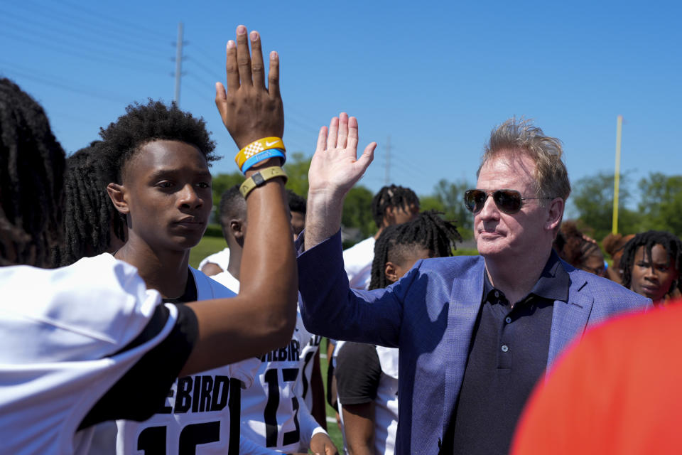 NFL Commissioner Roger Goodell hi-fives a Pearl-Cohn High School football player after a bill signing ceremony Tuesday, May 21, 2024, in Nashville, Tenn. Gov. Bill Lee signed a bill requiring all Tennessee high schools to keep an automated external defibrillator available during classes along with all athletic practices and games. (AP Photo/George Walker IV)