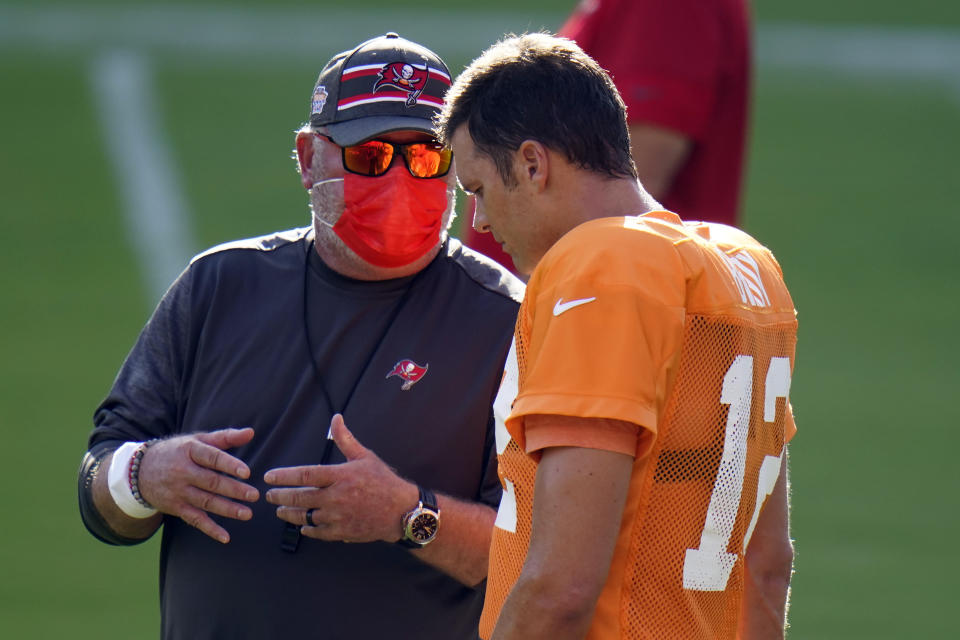 Tampa Bay Buccaneers head coach Bruce Arians talks to quarterback Tom Brady (12) during an NFL football training camp practice Friday, Aug. 28, 2020, in Tampa, Fla. (AP Photo/Chris O'Meara)