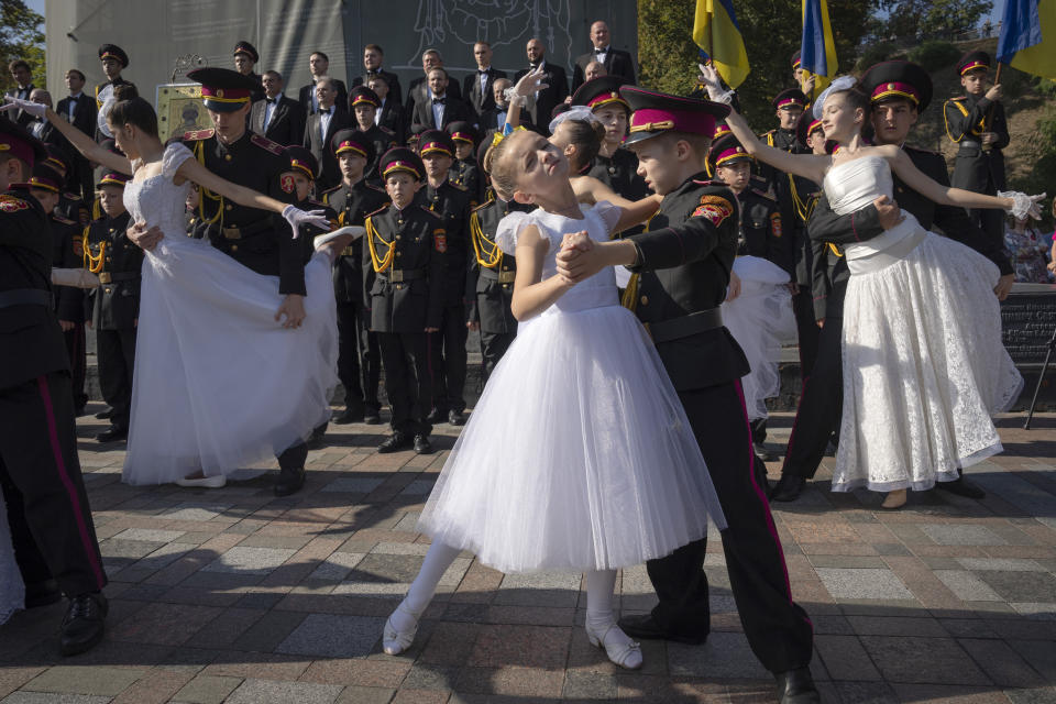 Young cadets and schoolgirls dance to mark a swearing-in ceremony at a monument to legendary Prince Volodymyr at the Ukrainian capital in Kyiv, Ukraine, Friday, Sept. 29, 2023. (AP Photo/Efrem Lukatsky)