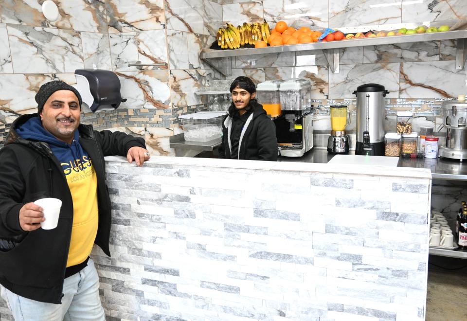 A customer drinks chai tea at the juice and drink bar inside the Shawarma Station.