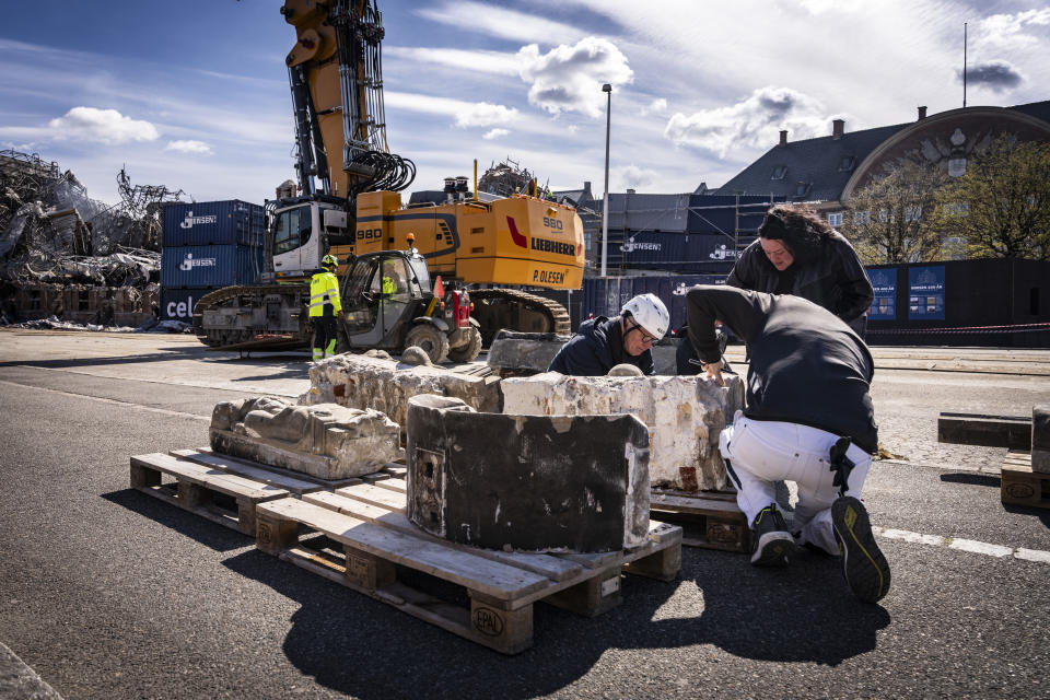 Ornaments from the Stock Exchange, which have been successfully salvaged from the burned building, lie on the ground in Copenhagen, Sunday, April 21, 2024. (Emil Nicolai Helms/Ritzau Scanpix via AP)