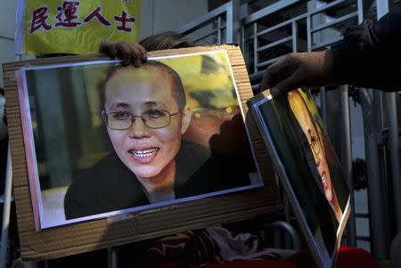 A pro-democracy protester holds a portrait of Liu Xia in Hong Kong December 5, 2013 REUTERS/Tyrone Siu