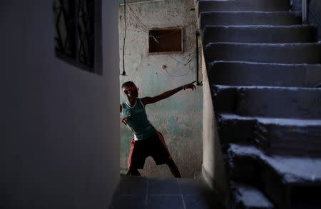 Anderson Guilherme, 16, who trains in the Mangueira Olympic Village, poses outside his house in Jacare neighbourhood in Rio de Janeiro, Brazil, August 16, 2016. REUTERS/Ricardo Moraes