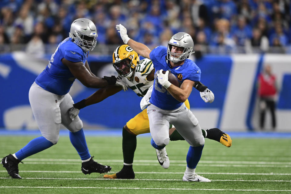 Detroit Lions tight end Sam LaPorta pulls away form Green Bay Packers linebacker Kingsley Enagbare (55) during the second half of an NFL football game, Thursday, Nov. 23, 2023, in Detroit. (AP Photo/David Dermer)