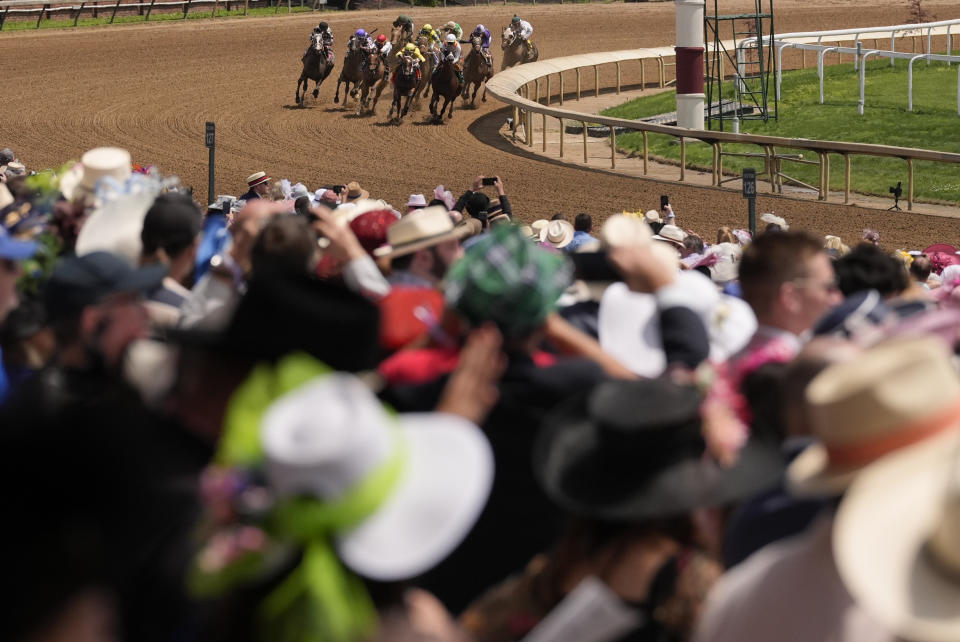 Race fans watch a race at Churchill Downs before the 150th running of the Kentucky Derby horse race Saturday, May 4, 2024, in Louisville, Ky. (AP Photo/Brynn Anderson)