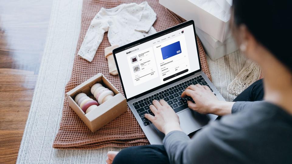 woman typing in payment information at checkout screen of online baby store