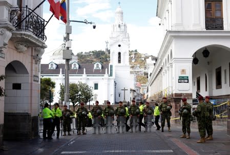 Soldiers and police stand guard next to the presidential palace after Ecuador's President Lenin Moreno's government ended four-decade-oil fuel subsidies, in Quito