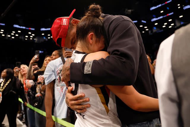 <p>Sarah Stier/Getty</p> Kelsey Plum #10 of the Las Vegas Aces reacts with husband Darren Waller after defeating the New York Liberty during Game Four of the 2023