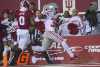 Ohio State running back TreVeyon Henderson (32) scores a touchdown in front of Indiana defensive back Raheem Layne II (0) in the first quarter of an NCAA college football game in Bloomington, Ind., Saturday, Oct. 23, 2021. (AP Photo/AJ Mast)
