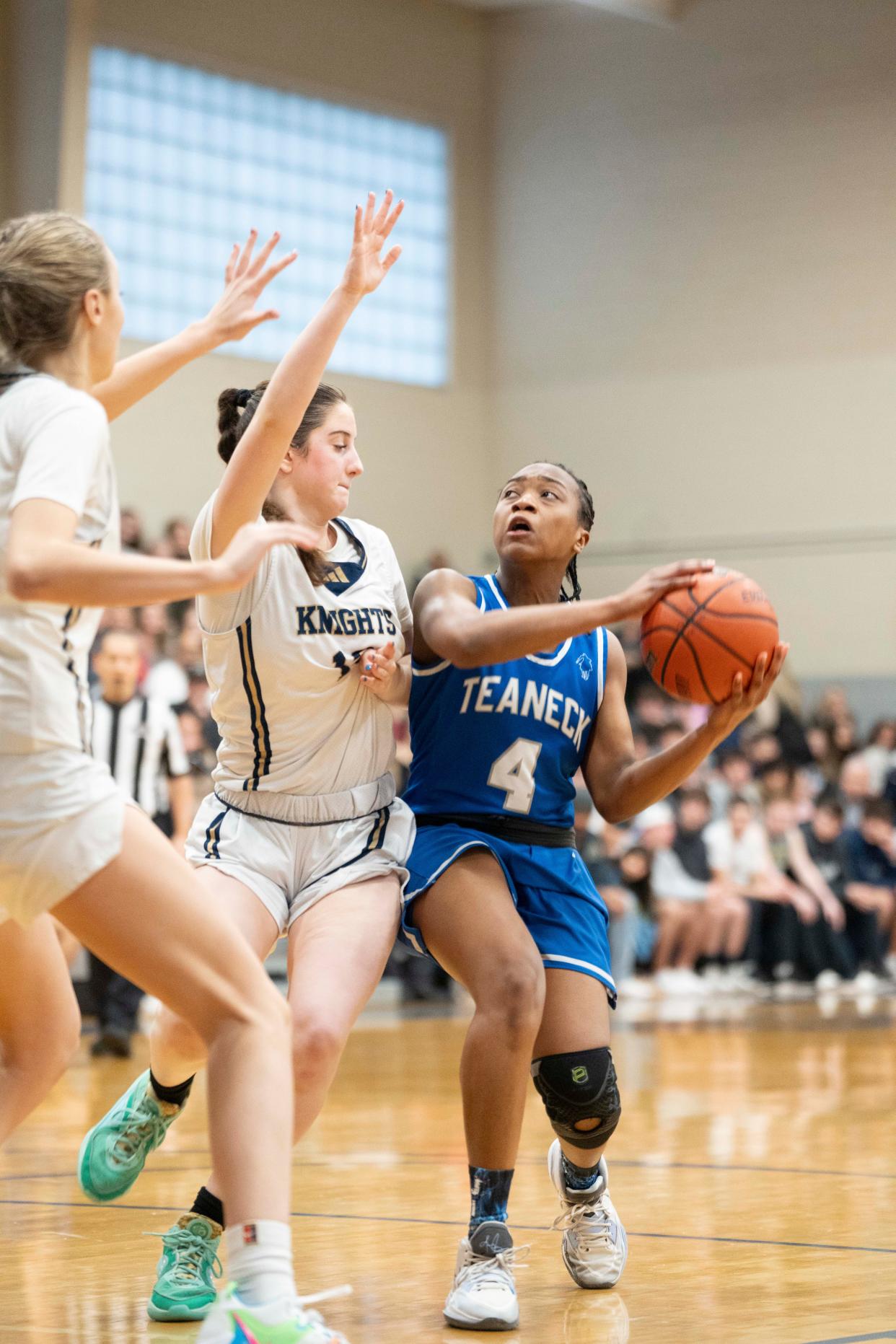 Mar 2, 2024; Teaneck, NJ, USA; Old Tappan at Teaneck in the NJSIAA North 1, Group 3 girls basketball final. T #4 Jillian Carter drives to the basket as OT #12 Mia Derrico defends.