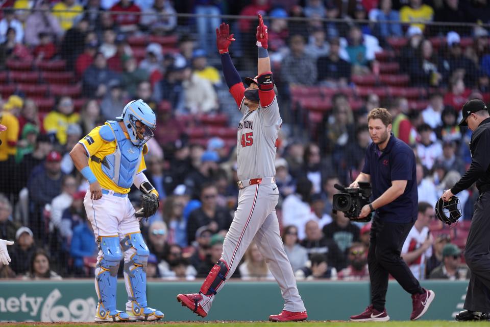 Washington Nationals' Joey Meneses (45) celebrates in front of Boston Red Sox catcher Reese McGuire, left, after hitting a solo home run during the second inning of a baseball game, Saturday, May 11, 2024, in Boston. (AP Photo/Michael Dwyer)