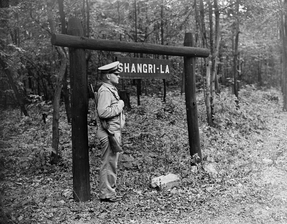 FILE - The entrance to Shangri-La, in Thurmont, Md., the wartime retreat of President Franklin D. Roosevelt, is guarded by Marine Pfc. Joseph Leszynski, Oct. 1, 1945. (AP Photo/Byron Rollins, File)