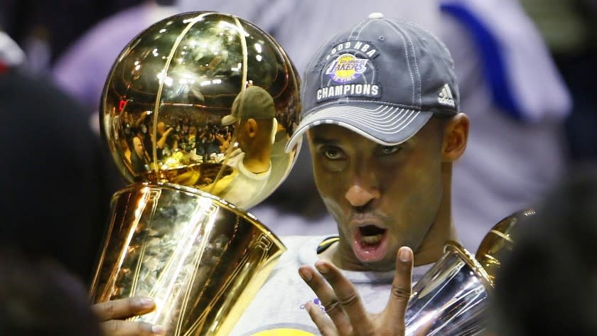 Lakers guard Kobe Bryant holds the Larry O'Brien Trophy while celebrating his fourth championship during the 2009 NBA Finals.
