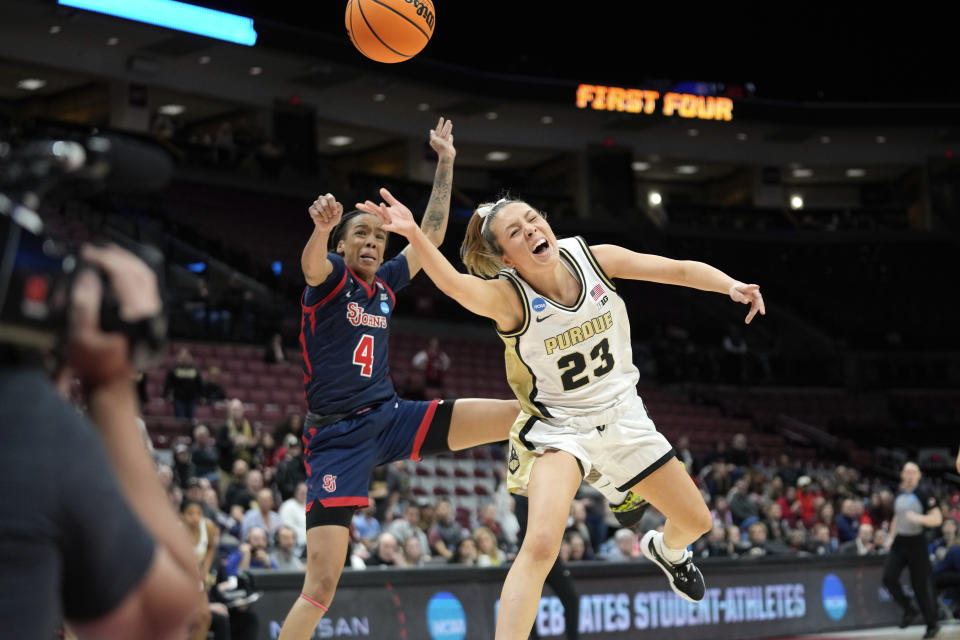 St. John's guard Jayla Everett (4) fouls Purdue guard Abbey Ellis (23) in the second half of a First Four women's college basketball game in the NCAA Tournament Thursday, March 16, 2023, in Columbus, Ohio. (AP Photo/Paul Sancya)