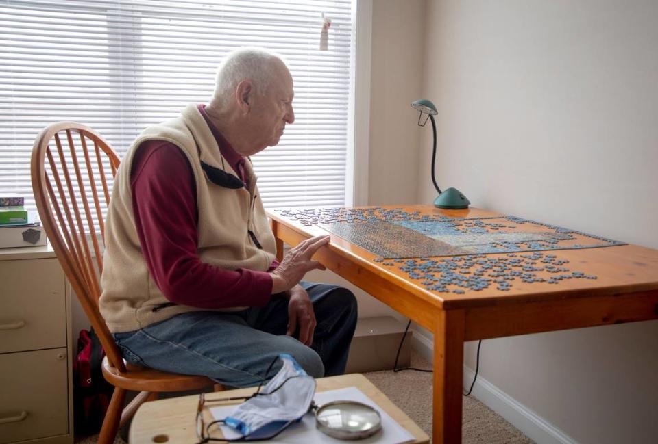 Albert Robinson works on a puzzle in his apartment, on Tuesday, Mar. 2, 2021, in Raleigh, N.C.