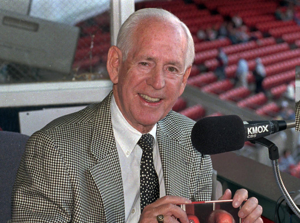 FILE - In this May 5, 1997, file photo, Jack Buck, announcer for the St. Louis Cardinals, poses in the KMOX broadcast booth at Busch Stadium, home of the Cardinals, in St. Louis. Best known for his work in baseball calling Cardinals games, Buck also had a big impact in football. He called the 1962 AFL title game that went double overtime and was one of the top announcers at CBS for more than a decade, calling the Ice Bowl and the Super Bowl in 1970. (AP Photo/Leon Algee, File)