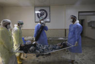 Medical workers carry a patient infected with the coronavirus on a stretcher at the Syrian American Medical Society Hospital, in the city of Idlib, northwest Syria, Monday, Sept. 20, 2021. Coronavirus cases are surging to the worst levels of the pandemic in Idlib province, a rebel stronghold in Syria — a particularly devastating development in a region where scores of hospitals have been bombed and that doctors and nurses have fled in droves during a decade of war. (AP Photo/Ghaith Alsayed)