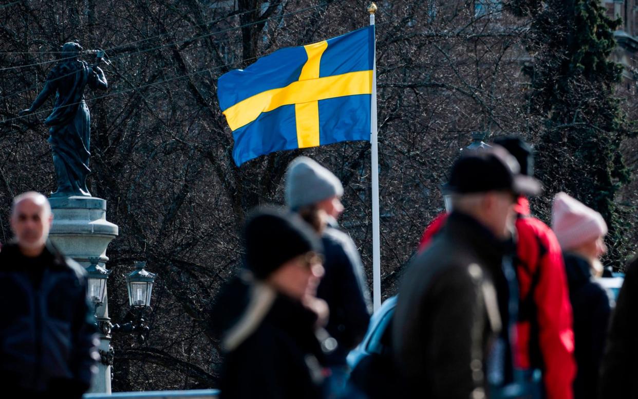 The Swedish flag is pictured in Stockholm during the the Covid-19 pamdemic - AFP