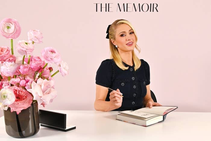 Paris Hilton signs books for fans at the UK launch of Paris: The Memoir at Selfridges London on March 17, 2023.