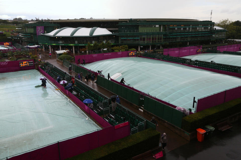 LONDON, ENGLAND - JULY 29: Rain covers protect the courts as rain delays play on Day 2 of the London 2012 Olympic Games at the All England Lawn Tennis and Croquet Club in Wimbledon on July 29, 2012 in London, England. (Photo by Clive Brunskill/Getty Images)