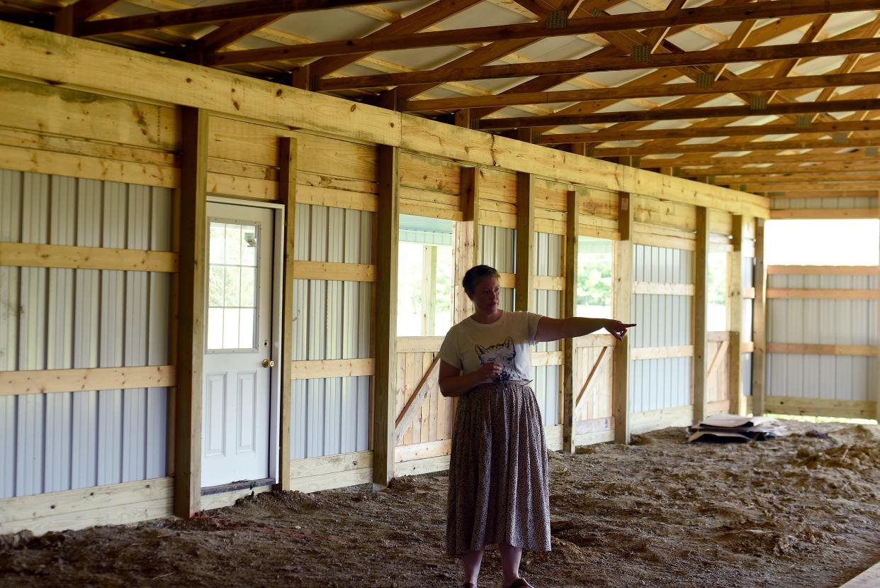 Amy Hurst, Director of Operations at Learning 4 Life Farm near Johnstown, gives a tour of the under construction barn for alpacas on Friday, July 22, 2022. The farm, which provides education and job training for students on the autism spectrum, held a summer open house to celebrate the construction of the new barn and expanding of their farm facilities and growing gardens.