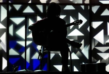 Latin recording artist Djavan works through his set during rehearsals for the first annual Latin Grammy Awards at the Staples Center in Los Angeles, September 12, 2000. Reuters photographer