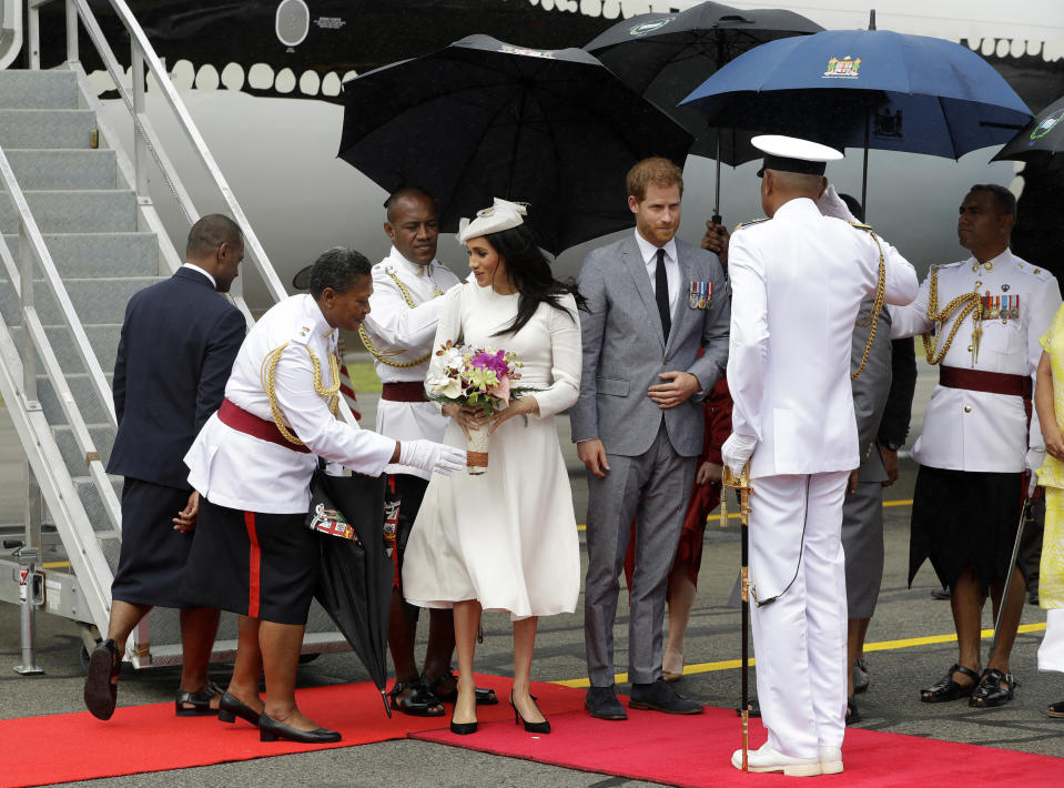 Britain's Prince Harry and Meghan, Duchess of Sussex on their arrival in Suva, Fiji, Tuesday, Oct. 23, 2018. Prince Harry and his wife Meghan are on day eight of their 16-day tour of Australia and the South Pacific.(AP Photo/Kirsty Wigglesworth,Pool)