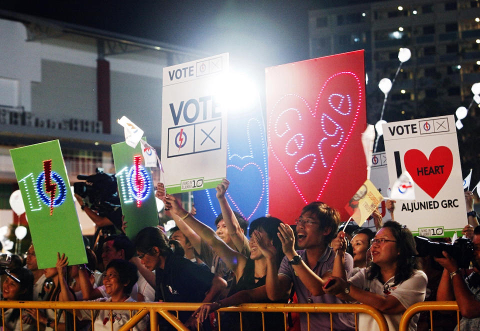 Supporters of the ruling People's Action Party (PAP) show their support during an election rally in Singapore May 5, 2011. The general election will be held on Saturday. (PHOTO: REUTERS/Edgar Su)