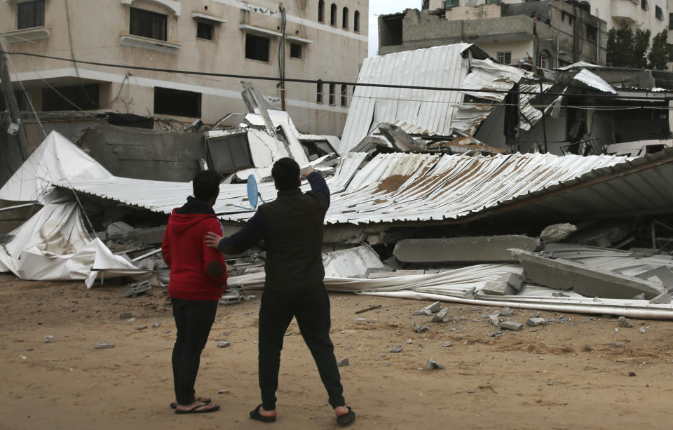 Palestinians inspect the damage of destroyed building belongs to Hamas ministry of prisoners hit by Israeli airstrikes in Gaza City, early Friday, Friday, March 15, 2019. Israeli warplanes attacked militant targets in the southern Gaza Strip early Friday in response to a rare rocket attack on the Israeli city of Tel Aviv, as the sides appeared to be hurtling toward a new round of violence. (AP Photo/Adel Hana)