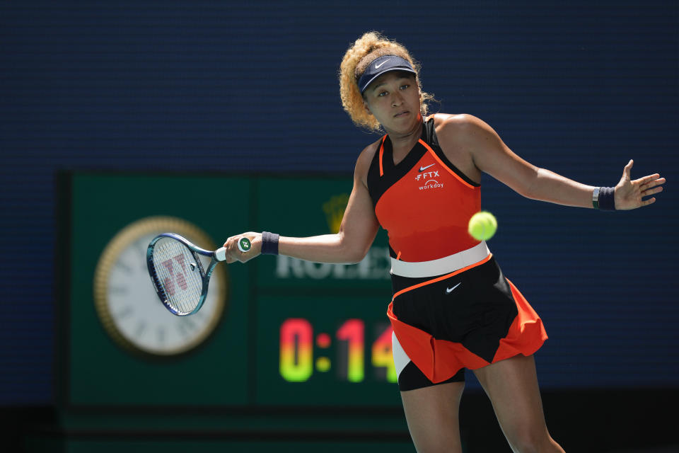 Naomi Osaka of Japan returns a ball against Astra Sharma of Australia in their first round women's match at the Miami Open tennis tournament, Wednesday, March 23, 2022, in Miami Gardens, Fla. (AP Photo/Rebecca Blackwell)