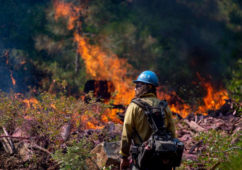 Tyler Medders of the Susanville Hot Shots keeps an eye out for embers at the North Fire near the North Fork Campgrounds in Placer County on Tuesday, September 4, 2018.