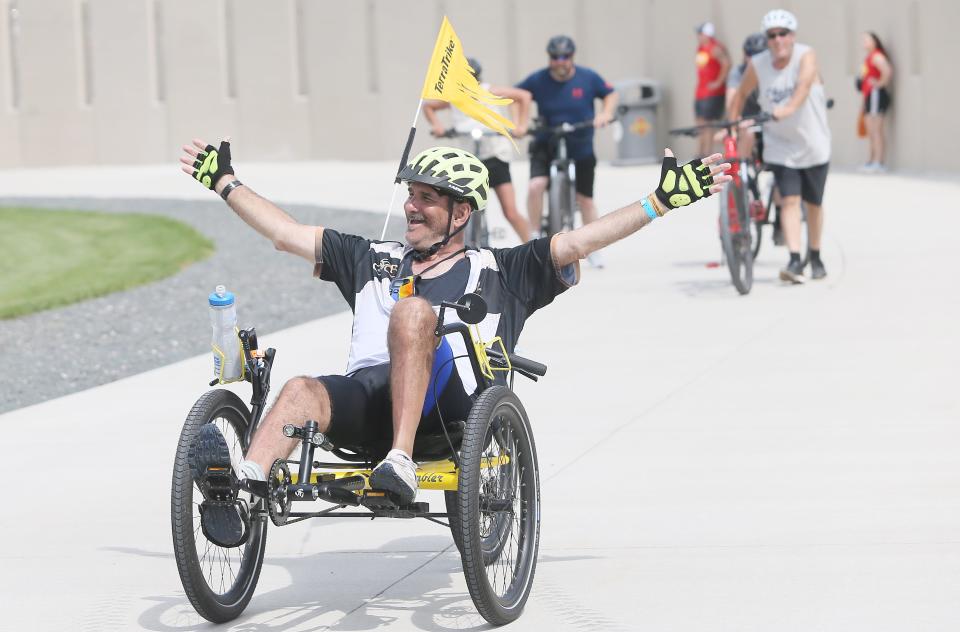 A RAGBRAI rider reacts as he enters Jack Trice Stadium to finish the Day 3 of the ride on Tuesday in Ames.