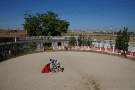 Bullfighter Alberto Lamelas (L) and bullfighter assistance Fernando Tellez practice a pass during a training session at an abandoned bullring in Madrid, Spain, June 23, 2017. REUTERS/Sergio Perez