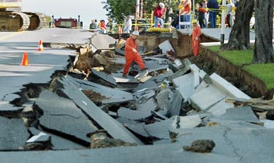 <b>A broken water main collapsed part of the street in Los Angeles, California, in December 2002. Sinkholes caused by water eroding the foundation of streets are a big problem in Los Angeles.</b> Mike Nelson/AFP/<a class="link " href="http://www.gettyimages.com/Home.aspx" rel="nofollow noopener" target="_blank" data-ylk="slk:Getty Images;elm:context_link;itc:0;sec:content-canvas">Getty Images</a>