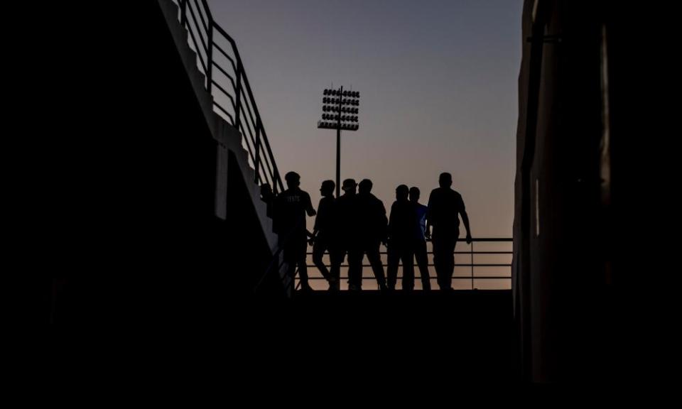 People watch a game at a ‘fan zone’ designed for migrant workers on the outskirts of Doha.
