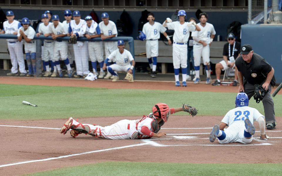 Hueneme catcher Christopher Rodriguez tags out Baldwin Park's Christian Escamilla during the CIF-SS Division 7 title game at Cal State Fullerton on Friday, May 20, 2022. Hueneme lost 4-2.