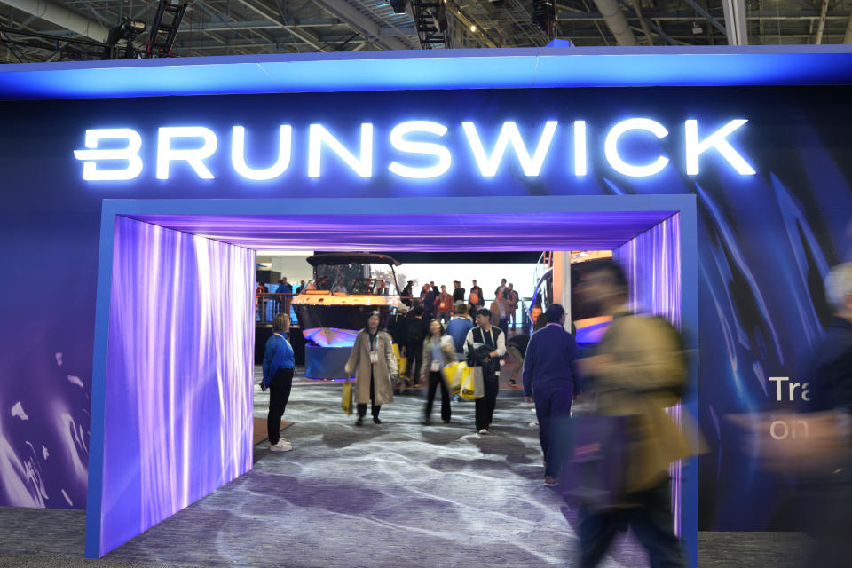 Attendees walk past the Brunswick booth during the CES tech show Tuesday, Jan. 9, 2024, in Las Vegas. (AP Photo/Ryan Sun)