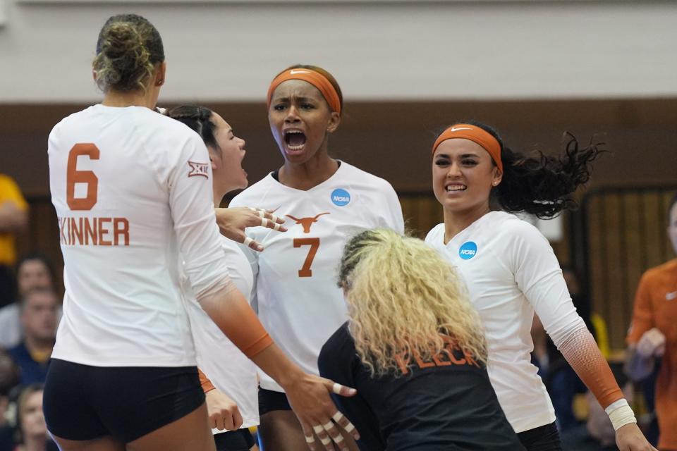 Texas middle blocker Asjia O'Neal cheers after a point. It was her kill that ended the match. The Longhorns will face Ohio State in Saturday's Elite Eight; Texas opened its season with a pair of wins over the Buckeyes in Columbus.