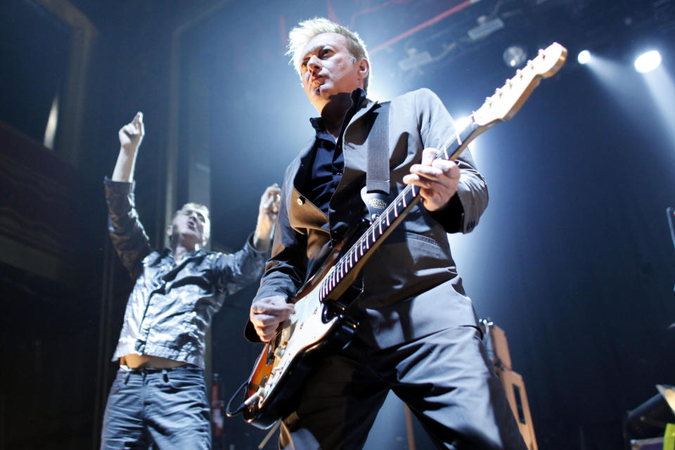 FILE- In this Feb. 8, 2011, file photo, Gang of Four's guitarist Andy Gill and singer Jon King, left, perform a concert at Webster Hall in New York. Gill, who led the highly influential British post-punk band Gang of Four, died Saturday, Feb. 1, 2020, in London, according to a statement from the band. He was 64. (AP Photo/Jason DeCrow, File)