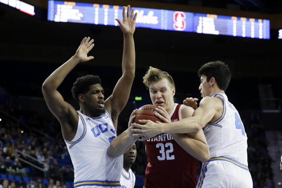 Stanford forward Lukas Kisunas drives the the basket between UCLA forward Cody Riley, left, and guard Jaime Jaquez Jr. during the first half of an NCAA college basketball game in Los Angeles, Wednesday, Jan. 15, 2020. (AP Photo/Chris Carlson)