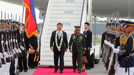 China's President Xi Jinping walks past honour guards upon his arrival at Ninoy Aquino International airport during a state visit in Manila, Philippines, November 20, 2018. At right is Philippine armed forces chief General Carlito Galvez. REUTERS/Erik De Castro