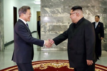 FILE PHOTO: South Korean President Moon Jae-in is greeted by North Korean leader Kim Jong Un during their summit at the truce village of Panmunjom, North Korea, in this handout picture provided by the Presidential Blue House on May 26, 2018. Picture taken on May 26, 2018.     The Presidential Blue House /Handout via REUTERS