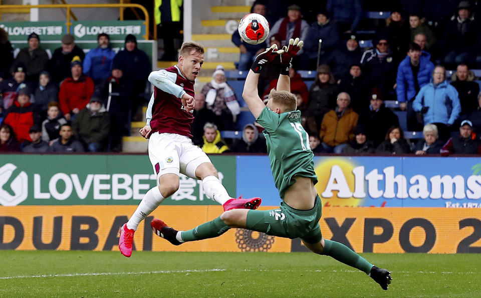 Bournemouth goalkeeper Aaron Ramsdale, right, saves a shot from Burnley's Matej Vydra during their English Premier League soccer match at Turf Moor in Burnley, England, Saturday Feb. 22, 2020. (Martin Rickett/PA via AP)