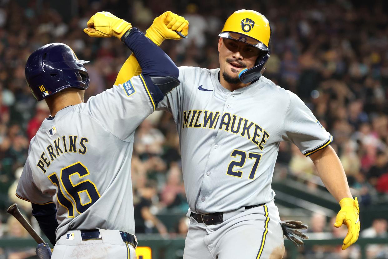 Willy Adames of the Brewers celebrates with Blake Perkins after Adames' solo home run in the fourth inning Saturday. It was one of two home runs for Adames, including a grand slam in the second inning.